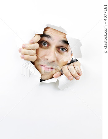 Face looking through hole in paper 4077161