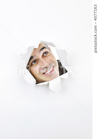 Face looking up through hole in paper 4077163