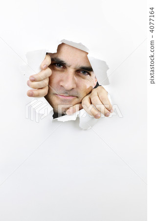 Face looking through hole in paper Face looking through hole in paper 4077164