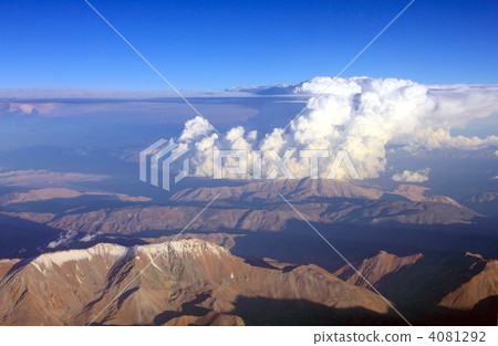 The South American Andes Mountains illuminated by the summer sun and the cloud that rises up The South American Andes Mountains illuminated by the summer sun and the cloud that rises up 4081292