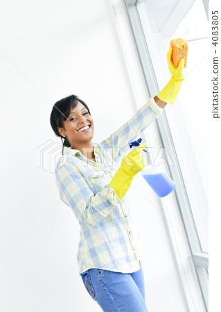Smiling woman cleaning windows Smiling woman cleaning windows 4083805