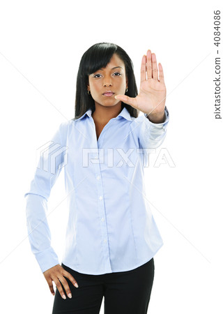 Serious young woman giving stop gesture Serious young woman giving stop gesture 4084086