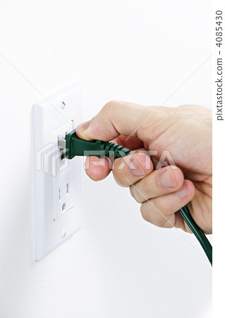 Hand inserting plug into outlet Hand inserting plug into outlet 4085430