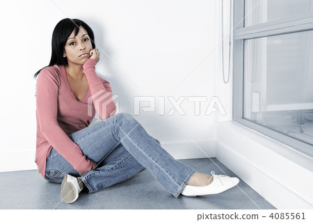 Depressed woman sitting on the floor 4085561