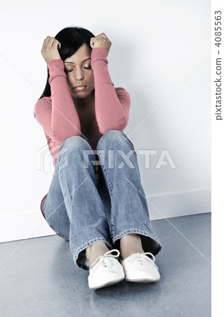 Depressed woman sitting on floor Depressed woman sitting on floor 4085563