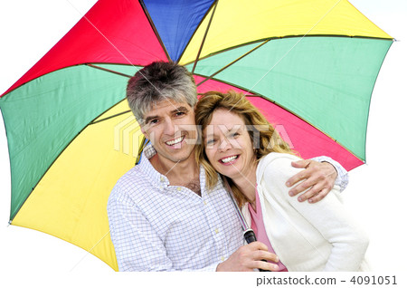 Happy mature couple with umbrella 4091051