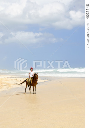 Girl riding horse on beach 4092548