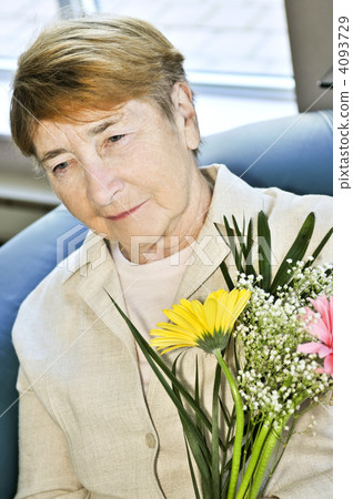 Sad elderly woman with flowers 4093729