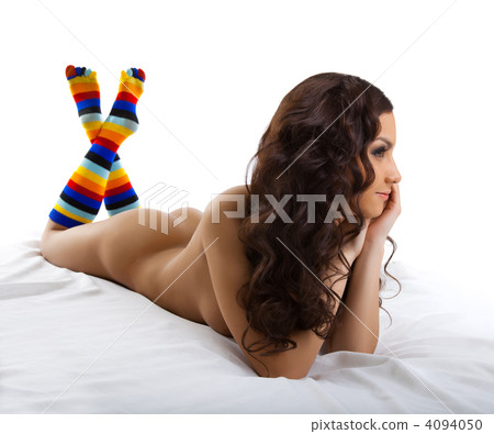 Young nude woman lay in color socks isolated Young nude woman lay in color socks isolated 4094050