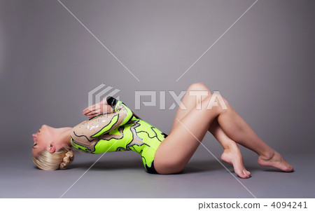 Beauty woman in gymnast suit posing on grey Beauty woman in gymnast suit posing on grey 4094241