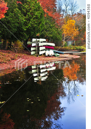 Fall forest reflections with canoes 4094368