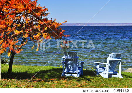 Wooden chairs on autumn lake Wooden chairs on autumn lake 4094380