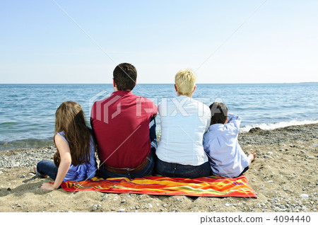 Family sitting at beach 4094440