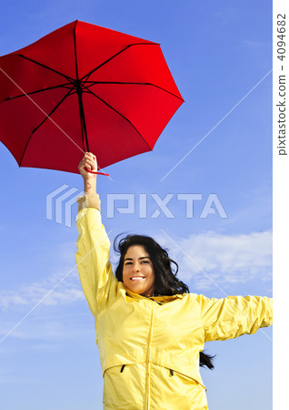 Beautiful young woman in raincoat with umbrella 4094682