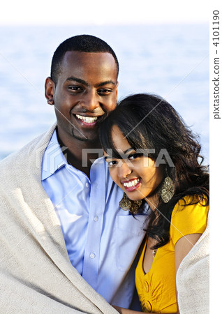 Happy couple sharing blanket Happy couple sharing blanket 4101190