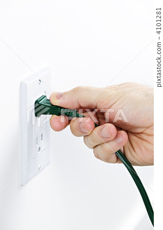 Hand removing plug from outlet 4101281