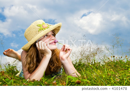 Young girl laying in meadow 4101478