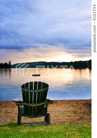 Wooden chair at sunset on beach Wooden chair at sunset on beach 4101554