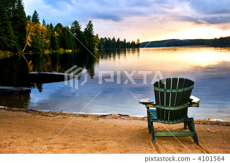Wooden chair at sunset on beach Wooden chair at sunset on beach 4101564