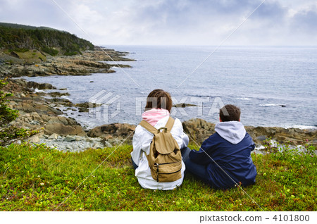 Children sitting at Atlantic coast in Newfoundland 4101800