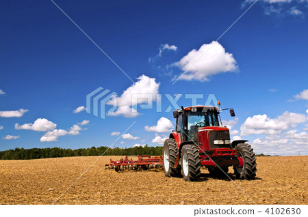 Tractor in plowed field 4102630