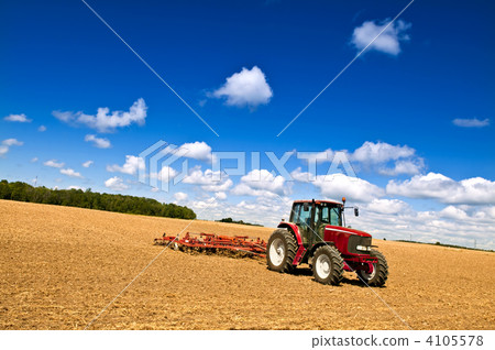 Tractor in plowed field 4105578
