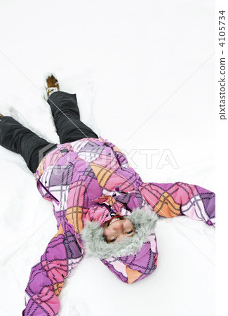 Girl making snow angel Girl making snow angel 4105734
