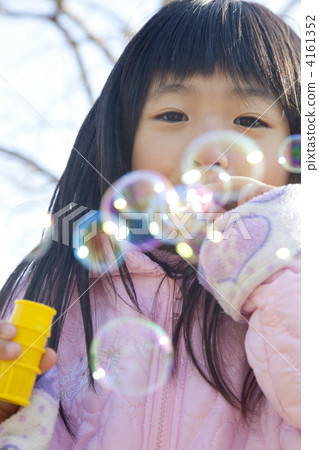 Girls playing with soap bubbles Girls playing with soap bubbles 4161352