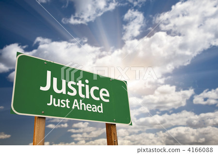 Justice Just Ahead Green Road Sign and Clouds Justice Just Ahead Green Road Sign and Clouds 4166088