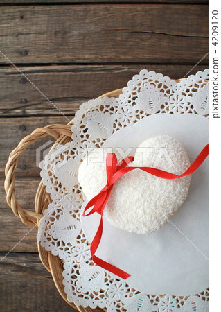 Heart-shaped coconut donut with red ribbon Heart-shaped coconut donut with red ribbon 4209120