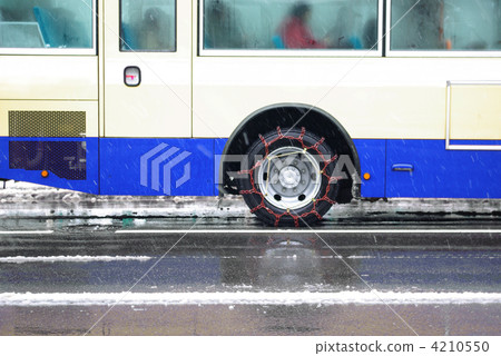 A bus wearing a tire chain A bus wearing a tire chain 4210550