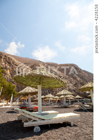 Sunbeds in Perissa, Santorini, Greece 4228158