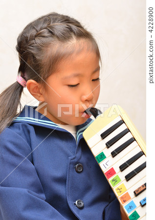 Girls practicing pianic at kindergarten 4228900