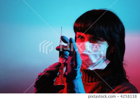 Medicine doctor with medical syringe in hands 4258138