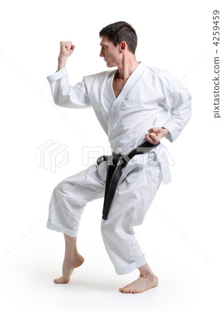 Karate. Man in a kimono with a white background Karate. Man in a kimono with a white background 4259459