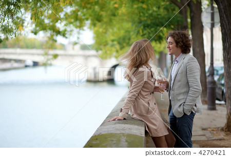 Young beautiful couple in Paris, drinking champagne at the emban 4270421
