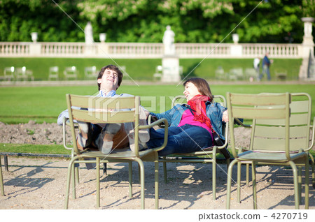 Young French couple relaxing in the Luxembourg Garden of Paris Young French couple relaxing in the Luxembourg Garden of Paris 4270719