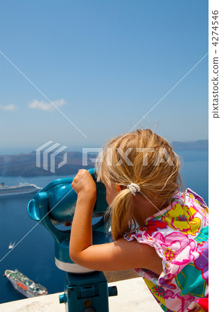 Girl looking with binoculars in Thira, Santorini, Greece 4274546