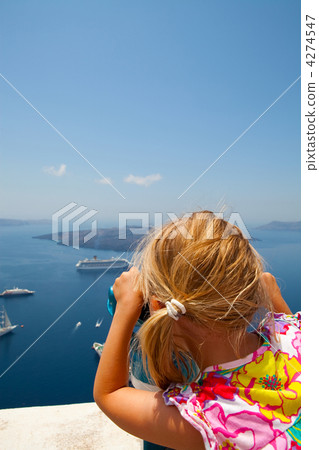 Girl looking with binoculars in Thira, Santorini, Greece Girl looking with binoculars in Thira, Santorini, Greece 4274547