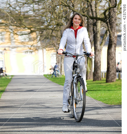 Girl walks city with bicycle Girl walks city with bicycle 4287698
