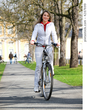 Girl walks city with bicycle 4287699