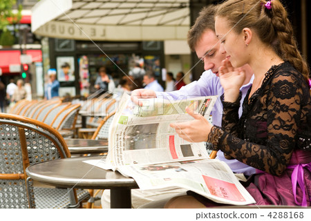 Romantic couple in Paris, reading newspaper in cafe Romantic couple in Paris, reading newspaper in cafe 4288168