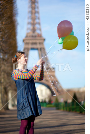 Girl in bright clothes with colourful balloons in Paris near the Girl in bright clothes with colourful balloons in Paris near the 4288350