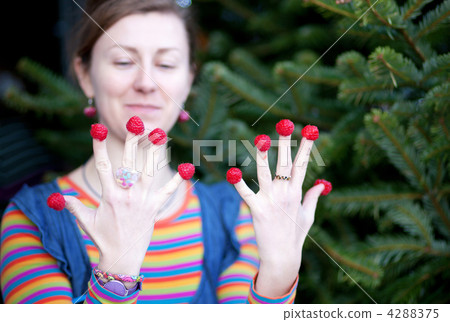 Beautiful young girl in bright clothes poses as Amelie with rasp 4288375
