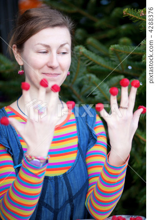 Beautiful young girl in bright clothes poses as Amelie with rasp 4288376