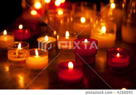 Church candles in red and yellow transparent chandeliers Church candles in red and yellow transparent chandeliers 4288895