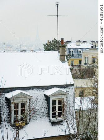 Rare snowy day in Paris. Parisian roofs covered with snow and th Rare snowy day in Paris. Parisian roofs covered with snow and th 4288951