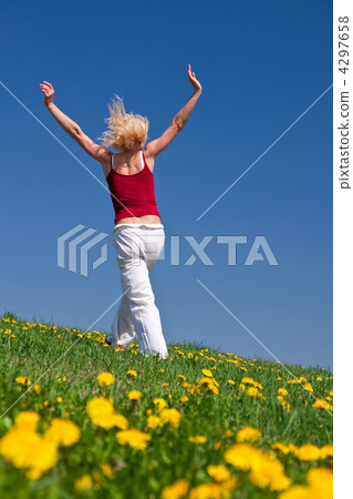 young woman in red outfit having fun on meadow 4297658