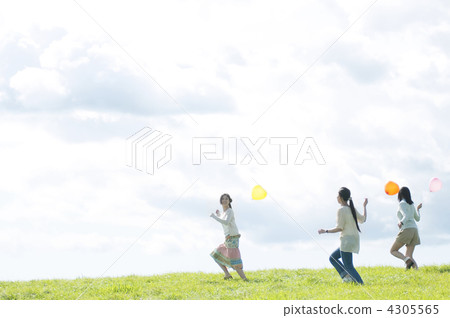 Three women who have balloons and run on the meadow Three women who have balloons and run on the meadow 4305565