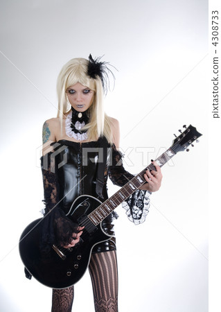 Alternative fashion girl playing guitar 4308733